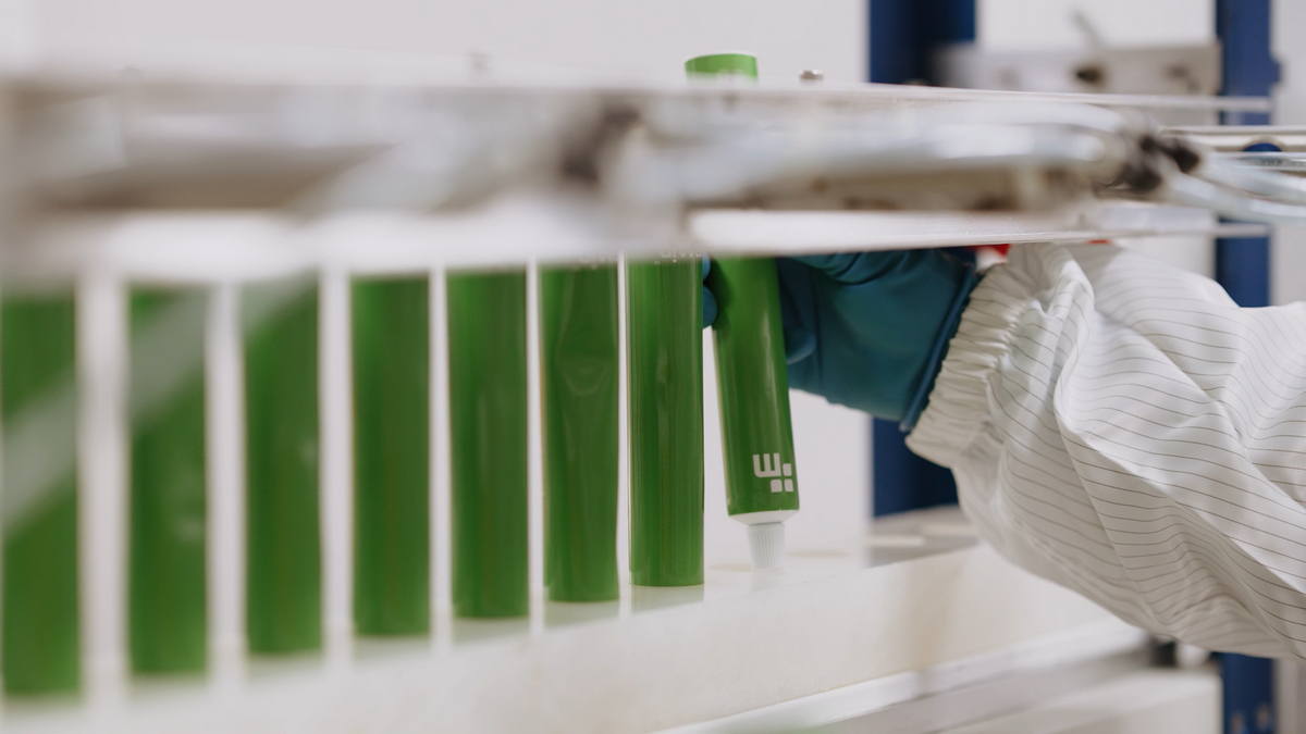 Pharmacist preparing compounded pain cream in a PCAB-accredited lab.